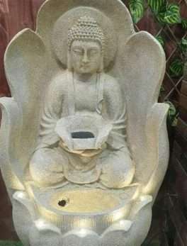 Buddha sitting on lotus flower water fountain