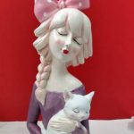 Leady holding cat idols